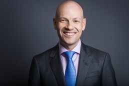 Corporate Headshot on Grey Background blue tie pink shirt by Vancouver Photographer Rob Trendiak