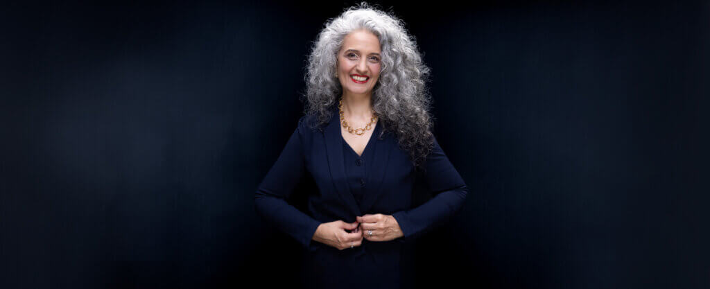 Bold Corporate Headshot of a woman with curly hair
