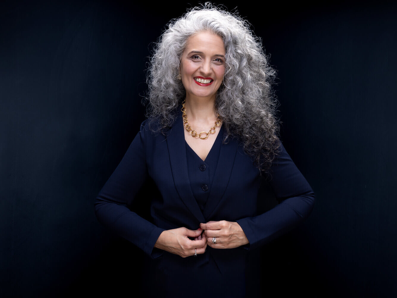 Bold Corporate Headshot of a woman with curly hair