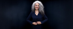 Bold Corporate Headshot of a woman with curly hair