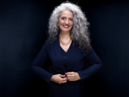 Bold Corporate Headshot of a woman with curly hair