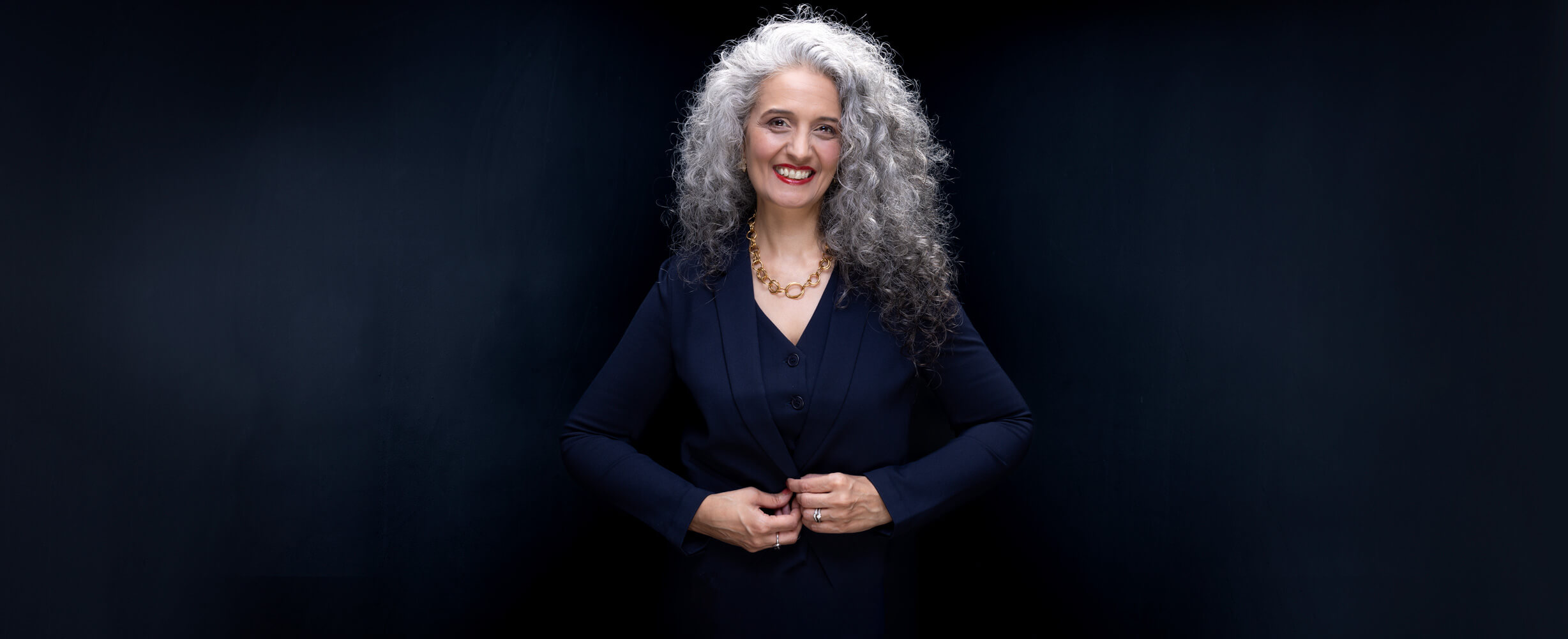 Bold Corporate Headshot of a woman with curly hair